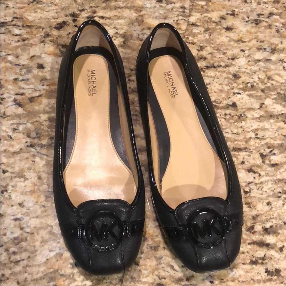 Women’s Michael Kors black flats.